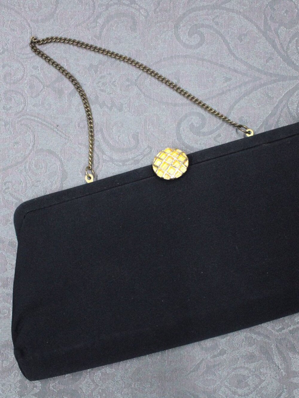 Vintage black silk clutch with gold flip-button closure and small strap